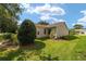 Green backyard with lawn and mature landscaping offering shade and privacy at 8537 Se 177Th Bartram Loop, The Villages, FL 32162