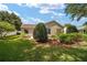 A lush backyard features a well-maintained lawn and mature landscaping at 8537 Se 177Th Bartram Loop, The Villages, FL 32162
