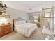 The bedroom features a queen bed, ceiling fan, and a window with lots of natural light at 8537 Se 177Th Bartram Loop, The Villages, FL 32162