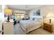 Bedroom with a queen bed, ceiling fan, dresser, nightstand, and window overlooking the front yard at 8537 Se 177Th Bartram Loop, The Villages, FL 32162