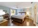Bedroom featuring a ceiling fan, hardwood floors, and a large window at 8537 Se 177Th Bartram Loop, The Villages, FL 32162