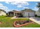 Home features a charming front porch, well-manicured lawn, and mature landscaping at 8537 Se 177Th Bartram Loop, The Villages, FL 32162