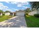 Home exterior featuring a large driveway and attached garage at 8537 Se 177Th Bartram Loop, The Villages, FL 32162