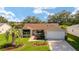 Charming single-story home with a well-manicured lawn, mature trees, and inviting curb appeal at 8537 Se 177Th Bartram Loop, The Villages, FL 32162
