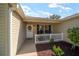 Inviting front porch with white picket fence, perfect for enjoying warm weather at 8537 Se 177Th Bartram Loop, The Villages, FL 32162