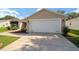 Attached two-car garage with an extended driveway at 8537 Se 177Th Bartram Loop, The Villages, FL 32162