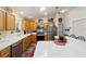 Bright kitchen with wooden cabinets, a breakfast bar, and stainless steel appliances at 8537 Se 177Th Bartram Loop, The Villages, FL 32162