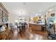 Open floor plan with hardwood floors, dining area, and a kitchen with an island at 8537 Se 177Th Bartram Loop, The Villages, FL 32162