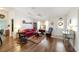 Well-lit living room featuring hardwood floors, a ceiling fan, and ample natural light at 8537 Se 177Th Bartram Loop, The Villages, FL 32162