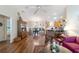 Open-concept living room with hardwood floors leading to the dining and kitchen areas at 8537 Se 177Th Bartram Loop, The Villages, FL 32162