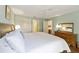 The main bedroom has a ceiling fan, hardwood floors, and a large dresser with mirror at 8537 Se 177Th Bartram Loop, The Villages, FL 32162