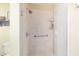 Shower with a glass door, shampoo shelves, and a handheld shower head at 8537 Se 177Th Bartram Loop, The Villages, FL 32162
