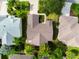An aerial view of the roof showing well-maintained landscaping and neighboring properties at 891 Lucky Ln, The Villages, FL 32162