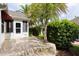 A view of the back patio of the home with a well-kept landscaped yard at 891 Lucky Ln, The Villages, FL 32162