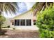 The backyard of the house boasts lush greenery, including trees and bushes, providing a private retreat at 891 Lucky Ln, The Villages, FL 32162