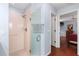 Ensuite bathroom featuring a glass-enclosed shower, with hardwood floors leading to the bedroom at 891 Lucky Ln, The Villages, FL 32162