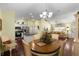 Open concept dining and living area with hardwood floors and stainless steel kitchen appliances at 891 Lucky Ln, The Villages, FL 32162