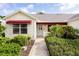 Charming home exterior featuring a well-manicured lawn, and a covered entrance way at 891 Lucky Ln, The Villages, FL 32162