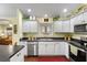 Modern kitchen with granite countertops, stainless steel appliances, and hardwood floors at 891 Lucky Ln, The Villages, FL 32162