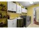 Functional laundry room with updated washer and dryer, cabinetry, and ample counter space for folding at 891 Lucky Ln, The Villages, FL 32162