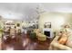 Open-concept living room with fireplace, ceiling fan, and adjacent dining area at 891 Lucky Ln, The Villages, FL 32162