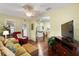 Cozy living room with ceiling fan, hardwood floors and open layout to the dining area at 891 Lucky Ln, The Villages, FL 32162