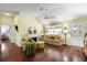 Cozy living room with a fireplace, a ceiling fan, and hardwood floors at 891 Lucky Ln, The Villages, FL 32162