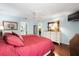Bedroom featuring an ensuite bathroom, ceiling fan, and hardwood floors at 891 Lucky Ln, The Villages, FL 32162