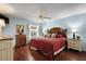 Comfortable bedroom features soft blue walls, hardwood floors, and a ceiling fan at 891 Lucky Ln, The Villages, FL 32162