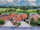 Gorgeous aerial view of homes with terracotta roofs, lush green landscaping, and golf course views at 903 Santa Anna Ln, Lady Lake, FL 32159