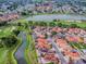 A high-angle view displays houses alongside a golf course, featuring scenic ponds and other community amenities at 903 Santa Anna Ln, Lady Lake, FL 32159
