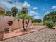 Serene backyard featuring a paver patio, lush landscaping, and mature palm trees, creating a tranquil outdoor space at 903 Santa Anna Ln, Lady Lake, FL 32159