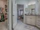 Bright and airy bathroom with vanity, a walk-in closet and a view into the next room at 903 Santa Anna Ln, Lady Lake, FL 32159