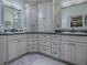 Elegant bathroom with gray vanity, double sinks, ample cabinet space and gray granite countertops at 903 Santa Anna Ln, Lady Lake, FL 32159