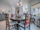 Dining room with a round table, wood chairs, and built-in bar seating looking into kitchen at 903 Santa Anna Ln, Lady Lake, FL 32159