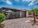 Exterior view of the screened-in patio, showing the pavers, patio furniture, and outdoor landscaping at 903 Santa Anna Ln, Lady Lake, FL 32159