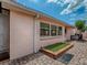 Charming exterior with well-maintained pavers, a small garden area, and view of the property's clean architectural lines at 903 Santa Anna Ln, Lady Lake, FL 32159