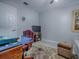 Office featuring wood desk, cozy chair, vintage area rug, and light colored walls and floors at 903 Santa Anna Ln, Lady Lake, FL 32159