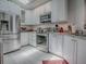 Bright kitchen featuring stainless steel appliances, white cabinets, and granite countertops at 903 Santa Anna Ln, Lady Lake, FL 32159
