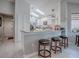 Spacious kitchen with granite countertops, white cabinets, and a breakfast bar with stools at 903 Santa Anna Ln, Lady Lake, FL 32159