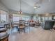 Open-concept living room with a dining table and access to the lanai at 903 Santa Anna Ln, Lady Lake, FL 32159