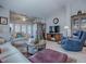 Open-concept living room with vaulted ceilings, wooden floors, and sliding glass doors leading to the patio at 903 Santa Anna Ln, Lady Lake, FL 32159