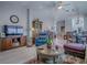 Spacious living room with wooden floors, comfortable furniture, and an open layout leading to the dining area at 903 Santa Anna Ln, Lady Lake, FL 32159