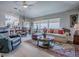 Inviting living room with wood floors, comfortable seating, and an open layout with seamless flow to the kitchen at 903 Santa Anna Ln, Lady Lake, FL 32159