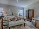 Comfortable main bedroom with floral comforter, and an ample amount of space at 903 Santa Anna Ln, Lady Lake, FL 32159