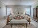 Main bedroom featuring a floral comforter, two side tables, and large windows at 903 Santa Anna Ln, Lady Lake, FL 32159