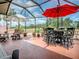 Screened patio with dining and lounge furniture, perfect for enjoying outdoor living and golf course views at 903 Santa Anna Ln, Lady Lake, FL 32159