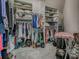 A fully organized walk-in closet with shelving and hanging rods full of clothing and storage at 903 Santa Anna Ln, Lady Lake, FL 32159