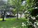Well-maintained backyard with lush lawn and a screened lanai visible from the yard at 9375 Woodbreeze Blvd, Windermere, FL 34786