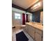 Bathroom with vanity sink, tiled floors, tub and shower combination, and ample light at 9375 Woodbreeze Blvd, Windermere, FL 34786